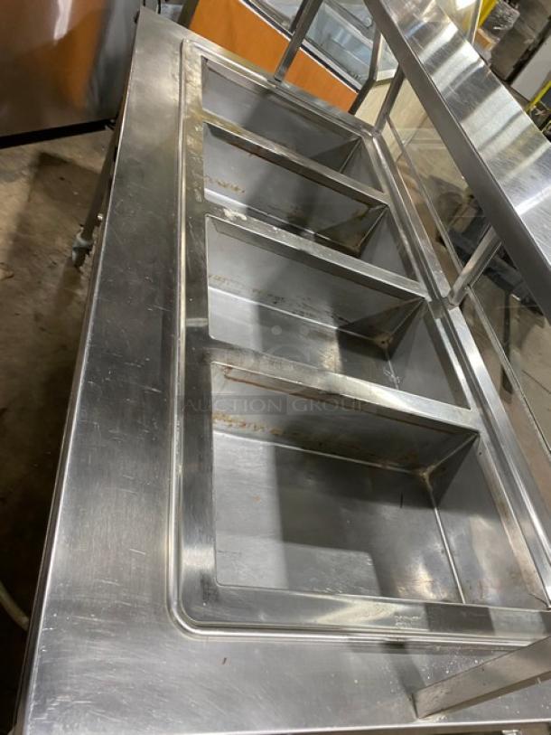 Atlas Metal commercial stainless steel 4-well hot food table, electric, model WIH-D&M-4, with sneeze guard, on casters.