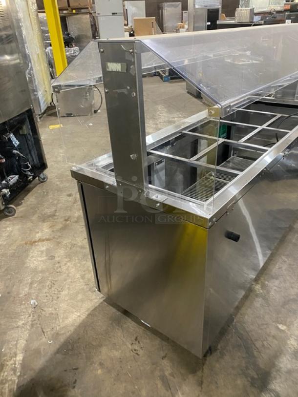 Turbo Air JBT-72-N stainless steel 3-door refrigerated salad bar display table with sneeze guard and poly coated wired rack.