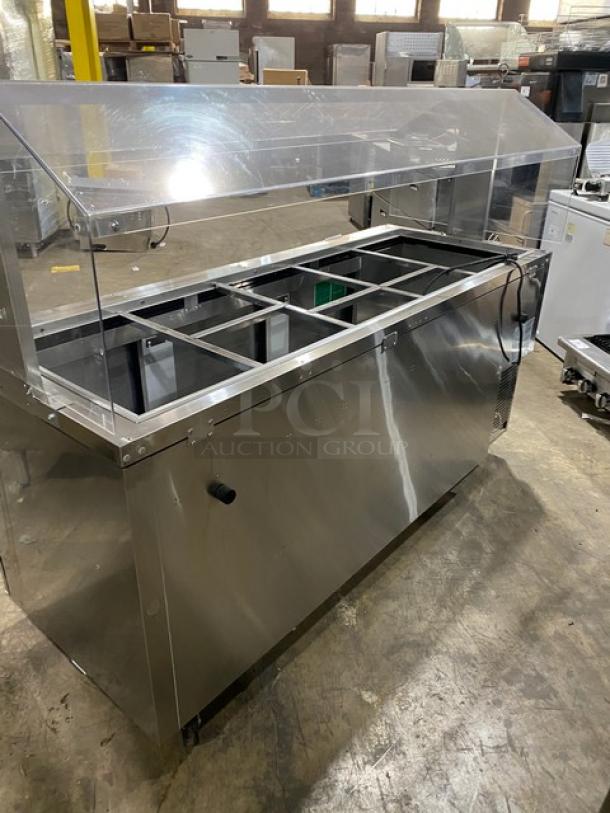 Turbo Air JBT-72-N stainless steel 3-door refrigerated buffet salad bar with sneeze guard and poly coated wire rack.