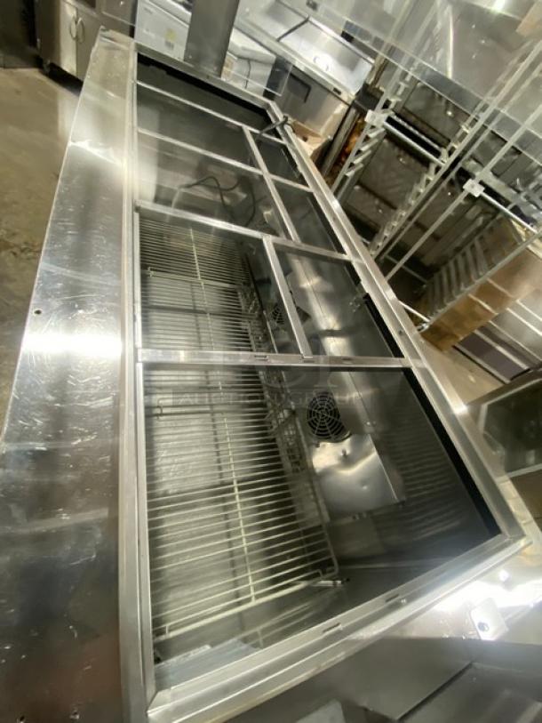 Turbo Air JBT-72-N stainless steel 3-door refrigerated buffet table with sneeze guard, poly coated rack, on casters.