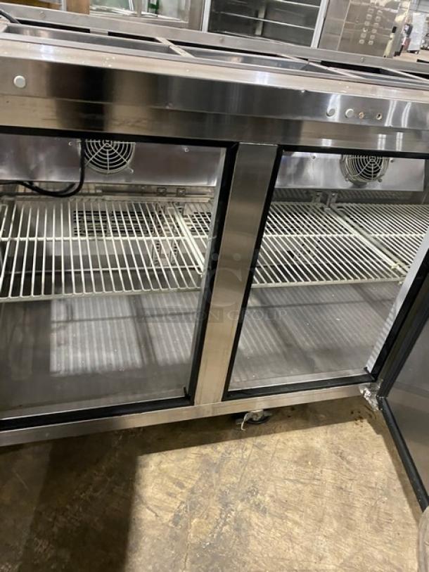 Turbo Air JBT72N stainless steel 3-door refrigerated salad bar with sneeze guard and poly-coated rack, on casters.