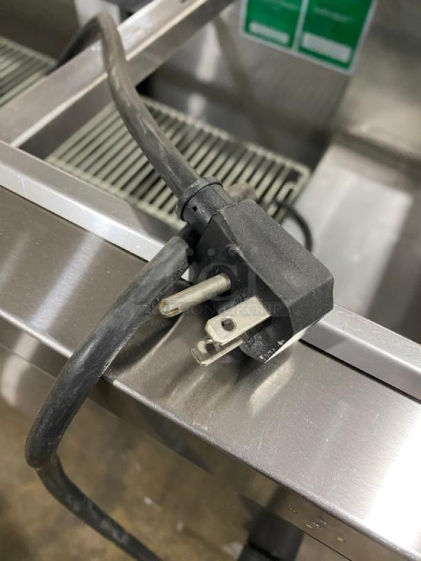 Turbo Air stainless steel refrigerated 3-door buffet table, model JBT-72-N, with casters and sneeze guard. Plug detail shown.