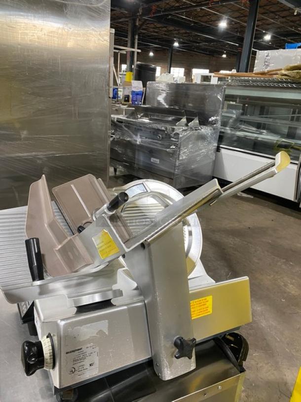 Bizerba SE12D commercial deli meat slicer, electric-powered, heavy-duty, countertop model, with visible labels, on legs, 120V.