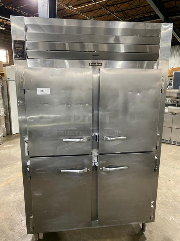 Traulsen stainless steel 4 half-door reach-in refrigerator with built-in pan slides, on legs, in good condition.