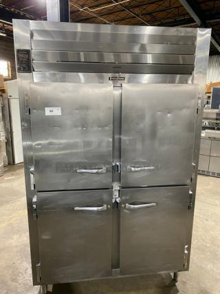 Traulsen stainless steel 4 half-door reach-in refrigerator with built-in pan slides, on legs, in good condition.