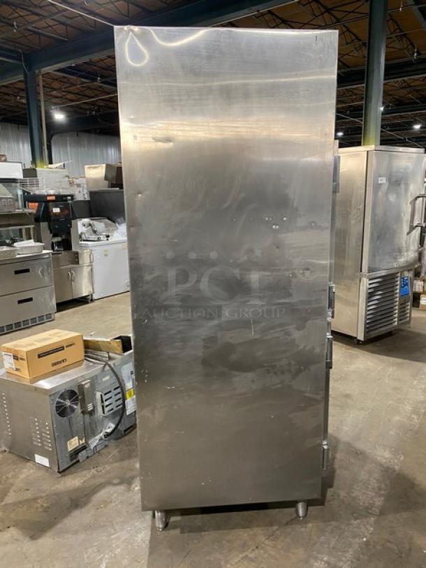 Traulsen commercial stainless steel 4 half-door double section reach-in refrigerator, built-in pan slides, on legs.