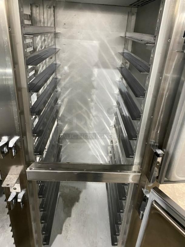 Traulsen stainless steel reach-in refrigerator with 4 half-doors, built-in pan slides, on legs. Interior visible, excellent condition.