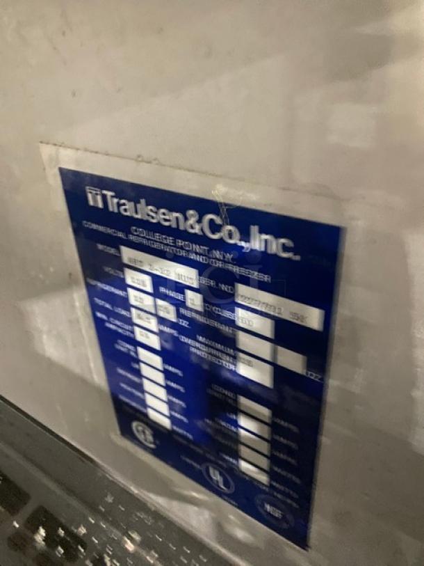 Traulsen Commercial Stainless Steel 4 Half-Door Double Section Reach-In Refrigerator, with built-in pan slides, visible manufacturer label.