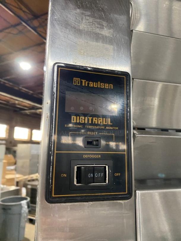 Traulsen stainless steel 4 half-door double section reach-in refrigerator, featuring built-in pan slides and digital temperature monitor.