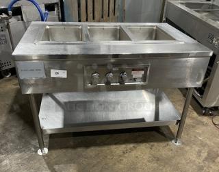 Wells MOD300TDM stainless steel 3-well hot food steam table with undershelf, electric, 208/240V, on legs.