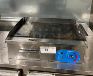 Commercial stainless steel electric countertop flat griddle with back and side splash, used condition, visible control panel.