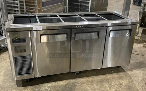 Turbo Air stainless steel 3-door refrigerated buffet table, model JBT-72-N, with sneeze guard and wired rack on casters.