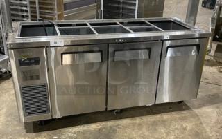 Turbo Air stainless steel 3-door refrigerated buffet table, model JBT-72-N, with sneeze guard and wired rack on casters.