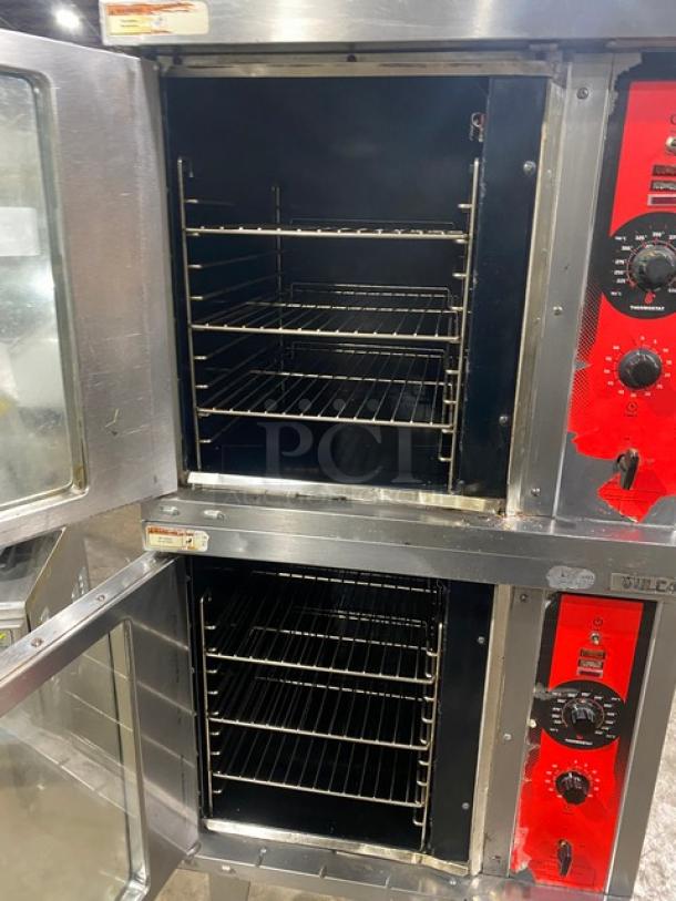 Vulcan commercial stainless steel double stacked gas convection oven with wired racks and control panel, mounted on legs.