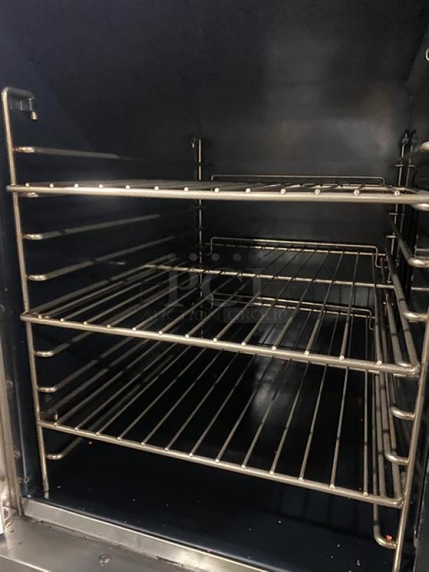 Vulcan commercial stainless steel gas convection oven interior, featuring multiple wired racks. Appears in clean condition.