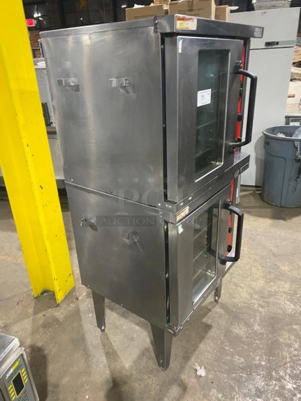 Vulcan stainless steel gas double-stacked convection oven, with wired rack, on legs. Used condition, visible controls.