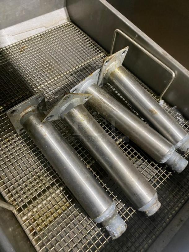 Pitco Solstice SELVBNB fryer heating elements on stainless steel mesh surface, showing moderate wear.