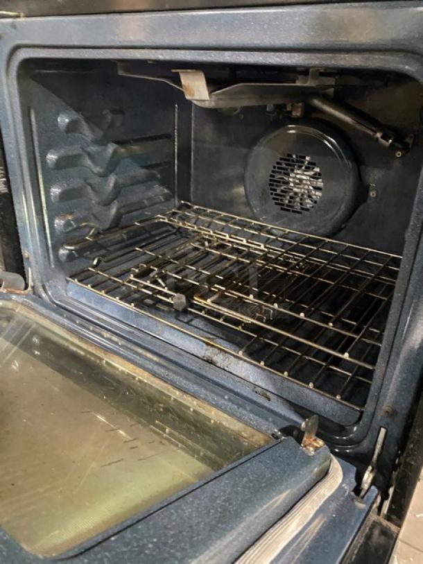 Frigidaire Professional Series gas oven interior with wired rack, Model FPGS3085KFH. Features stainless steel finish and warming drawer.