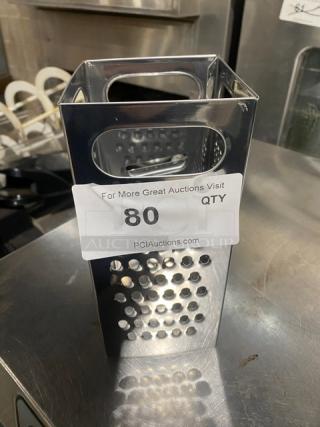 Commercial stainless steel 4-sided handheld box grater in excellent condition, featuring ergonomic handle. Auction label reads "80."