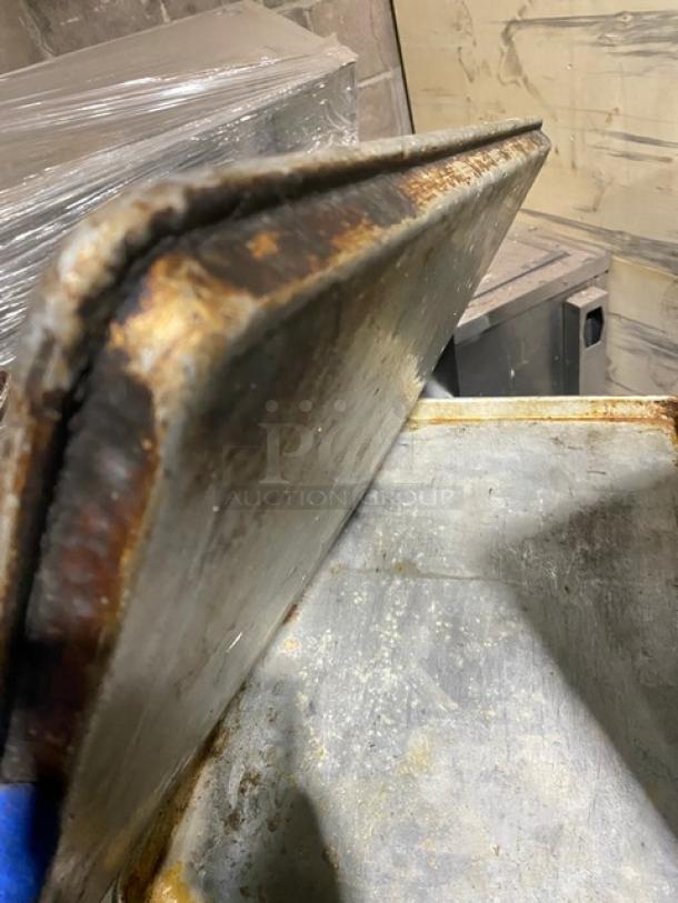 Commercial rectangular baking sheet pan, well-used, with visible rust and wear; sold in a lot of four.