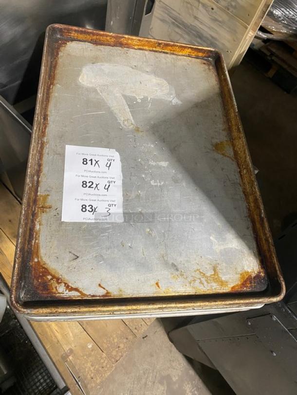 Commercial rectangular baking sheet pan with visible wear and rust. Includes auction labels indicating 4X bid option.