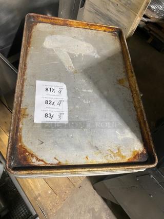 Commercial rectangular baking sheet pan with visible wear and rust. Includes auction labels indicating 4X bid option.