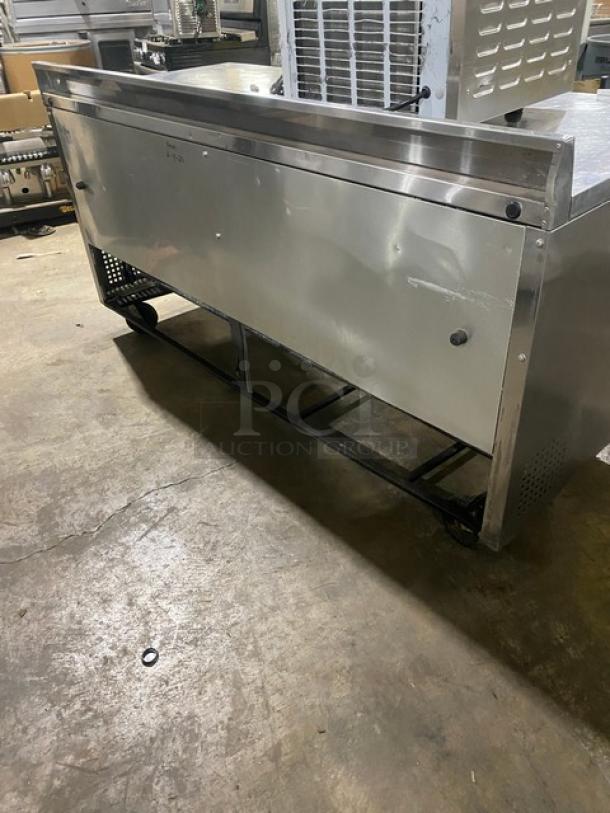 True Commercial 3 Door Stainless Steel Worktop Refrigerator, Model TWT-72, with casters and upturned backsplash. Energy Star certified.