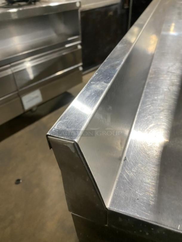 True Commercial Stainless Steel 3 Door Worktop Refrigerator, Model TWT-72, Energy Star Certified, upturned backsplash, on casters.