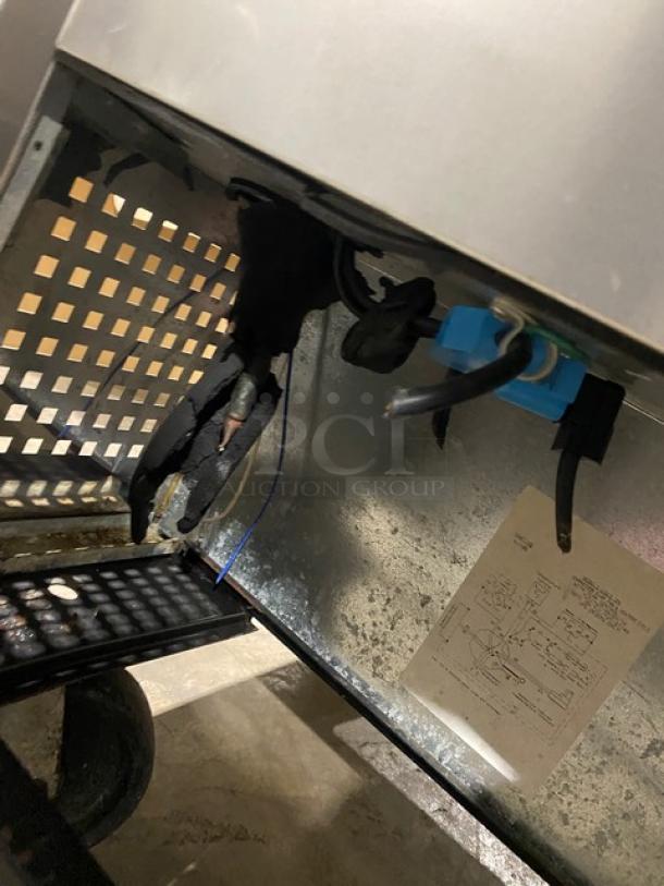 True TWT-72 commercial stainless steel 3-door worktop refrigerator with upturned backsplash, Energy Star certified, on casters.