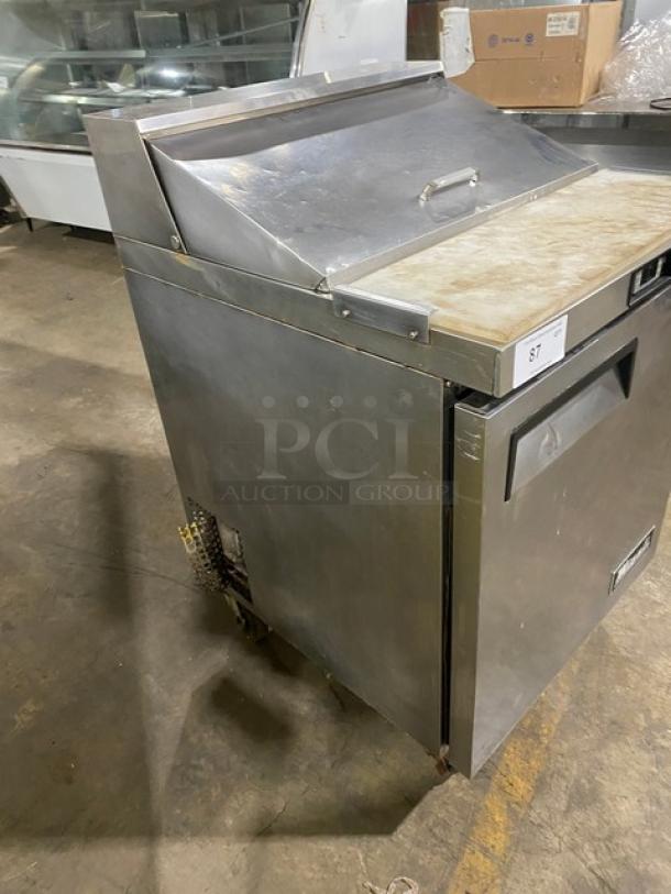 Migali stainless steel refrigerated prep table with cutting board, poly-coated rack, single door, on casters.