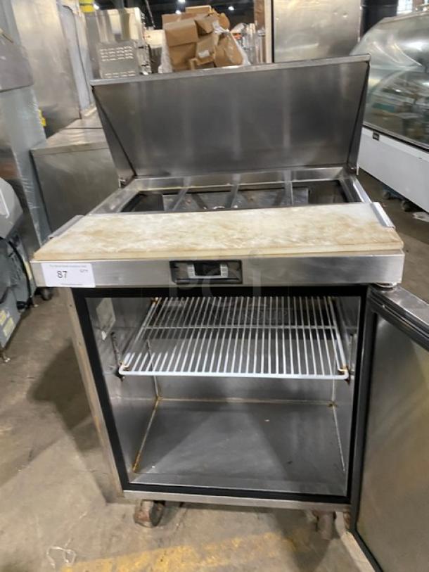 Migali stainless steel refrigerated prep table, single door, bain marie style, includes cutting board and poly-coated rack, on casters.