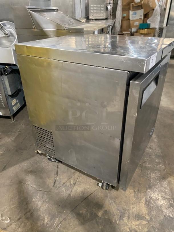 Atosa stainless steel single door undercounter freezer, poly coated wired rack, 115V, on casters, industrial setting.