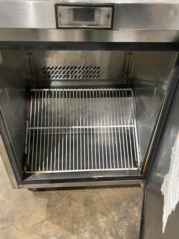 Atosa commercial stainless steel single door undercounter worktop freezer with poly-coated wired rack, 115V, on casters.