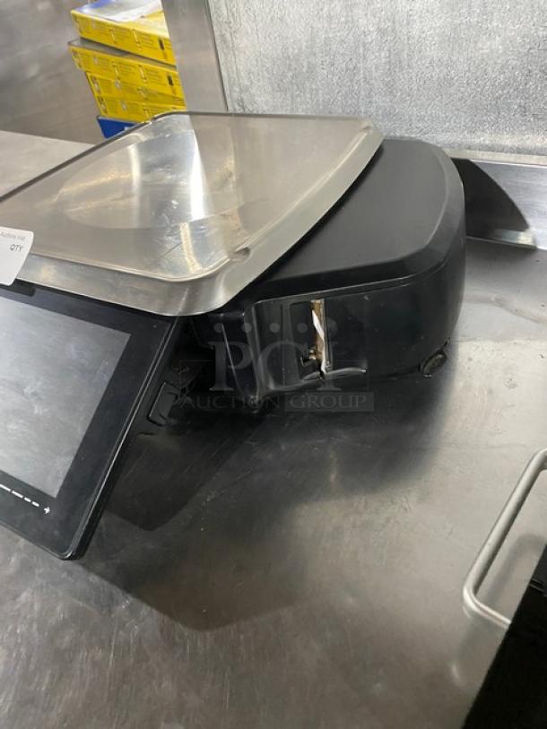 Hobart HT-Series HTi-7LH4 black electric price computing scale/printer, with stainless steel worktop and dual displays.