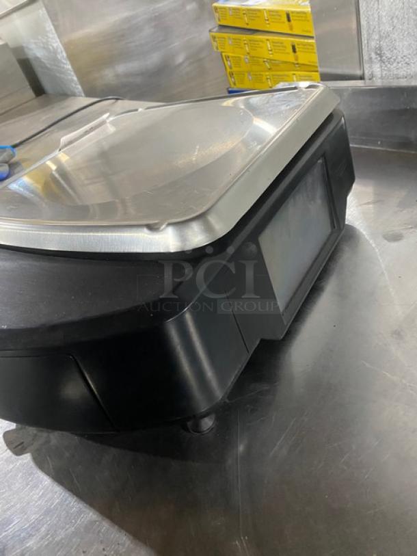 Hobart HTi7LH4 commercial scale/printer combo, stainless steel worktop, dual displays, black casing, electric.