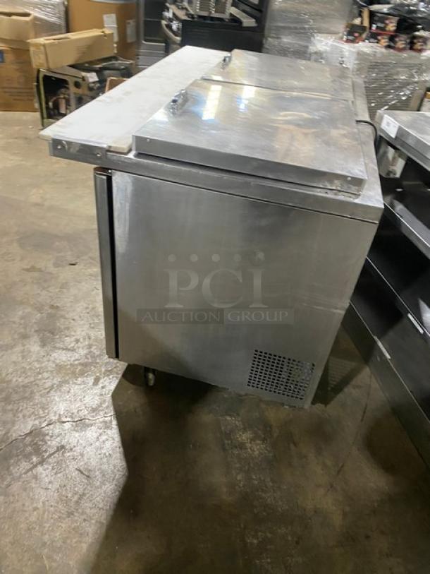 Turbo Air Super Deluxe 2-door stainless steel refrigerated prep table, model TST-60SD-24-N, with cutting board and rack, on casters.