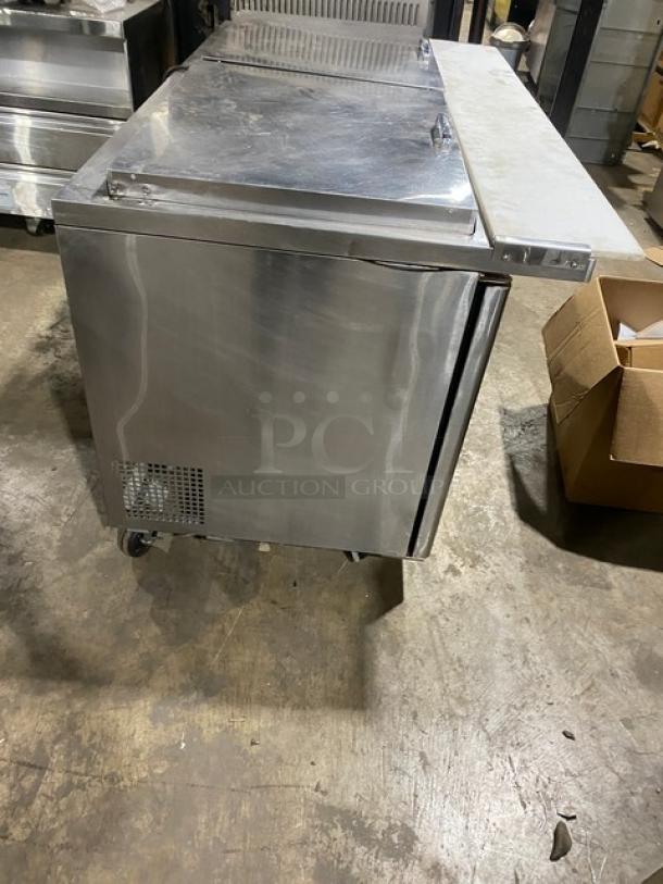 Turbo Air Super Deluxe 2 Door Refrigerated Prep Table, Model TST-60SD-24-N, stainless steel, on casters, with cutting board.