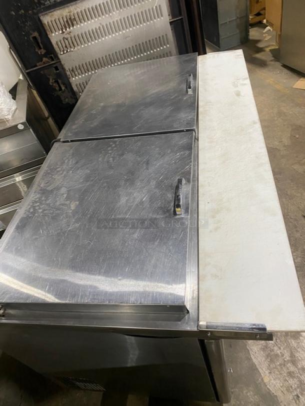 Turbo Air Super Deluxe stainless steel 2-door refrigerated prep table, model TST-60SD-24-N, with cutting board and rack.
