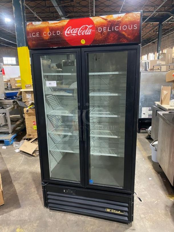 True Coca-Cola style commercial black double glass swing door reach-in merchandiser refrigerator, model GDM-35EM.