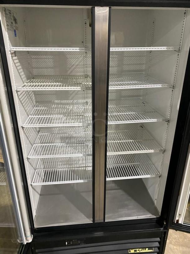 True Coca-Cola style commercial black double glass swing door reach-in merchandiser refrigerator, model GDM-35EM. Energy Star certified, includes poly-coated wired racks.