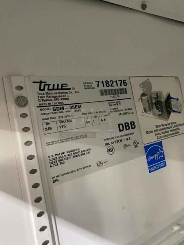 True Coca-Cola style commercial refrigerator, model GDM-35EM. Features double glass doors, poly coated rack, energy-efficient.