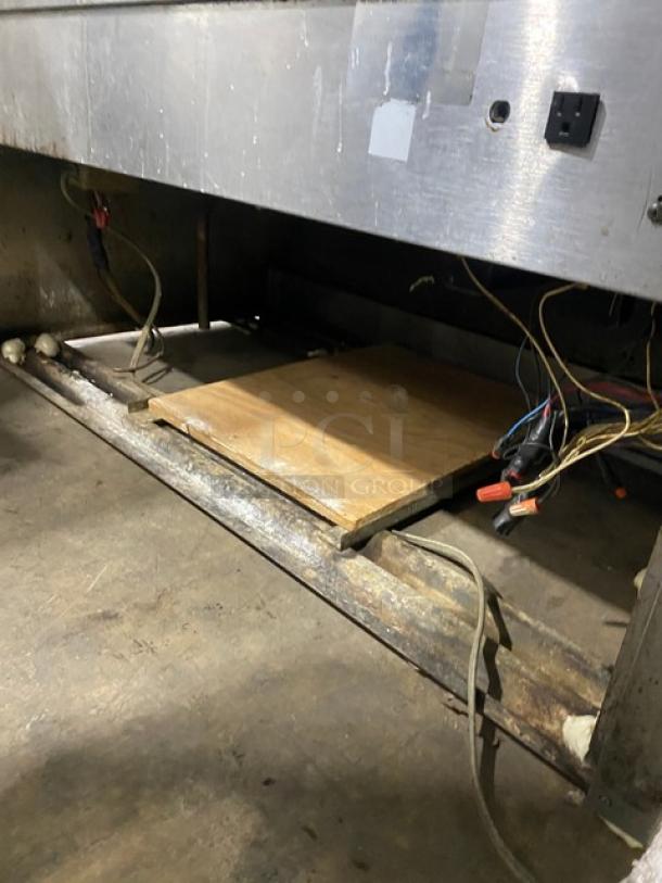 Commercial stainless steel bakery display showcase with slanted glass, poly-coated wire rack, and rear sliding glass doors.