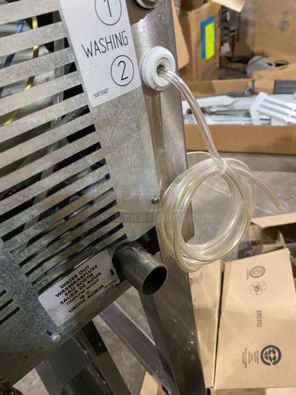 Axis commercial stainless steel electric combi oven, digital controls, wired oven rack, 3 phase, on legs, side label showing washing instructions and water hose attached.