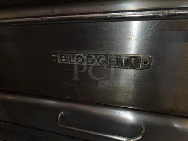 Blodgett stainless steel double stacked pizza deck oven, on legs, with logo plate, showing some wear.