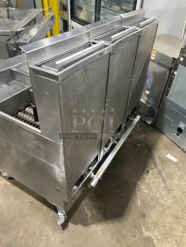 Pitco SSH60 triple-bay deep fryer, stainless steel, natural gas, with filter, backsplash, basket hanger, on casters.