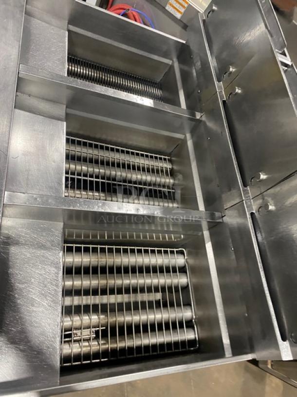 Pitco SSH60 commercial stainless steel 50 lb triple-bay deep fat fryer system, with filter, backsplash, basket hanger, on casters.