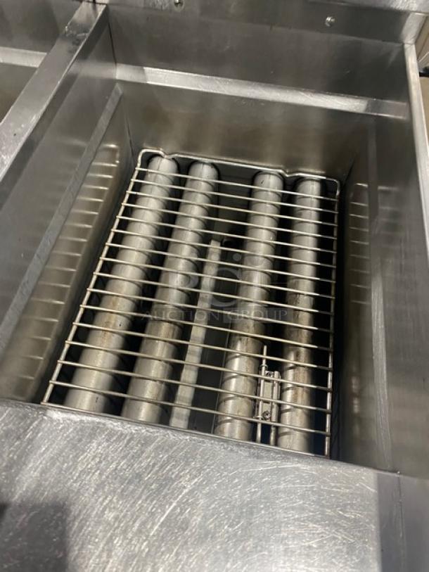 Pitco SSH60 commercial stainless steel 50 lb. triple-bay deep fat fryer with filter, backsplash, and basket hanger. Natural gas, 115V, on casters.