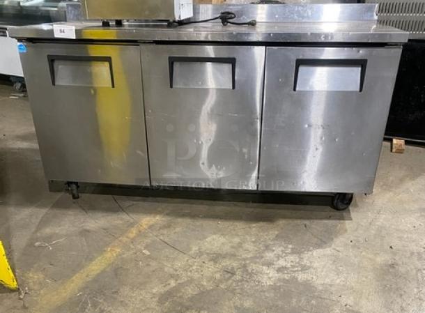 True TWT-72 commercial stainless steel 3-door worktop refrigerator, Energy Star certified, with upturned backsplash, on casters.
