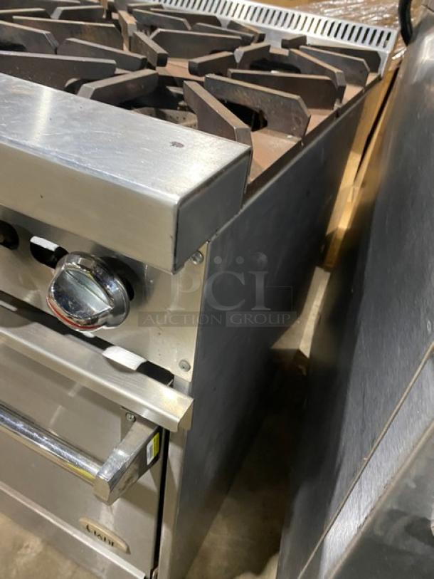 Jade Range Bistro Series 4-burner commercial stainless steel gas range/oven combo with wired oven rack, on legs.