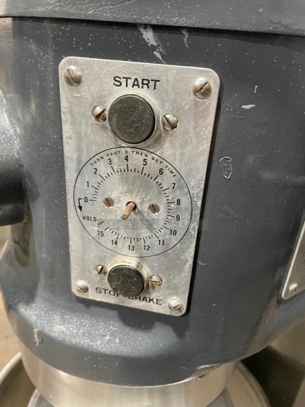 Hobart H-600T commercial mixer, charcoal gray, with control panel and start/stop knobs visible. 60 qt, electric, 220V, 3 phase.